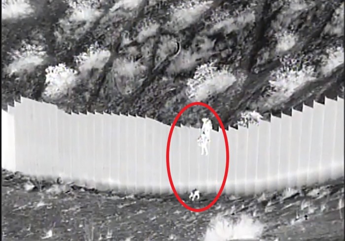U.S. Border Patrol agents from the Santa Teresa Station in New Mexico rescue two toddlers dropped over a border barrier on March 30, 2021. 