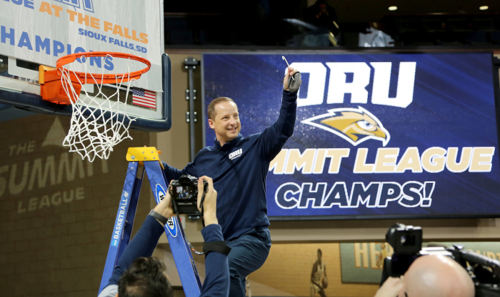 ORU Coach Paul Mills celebrates after being named the Summit League champions in Sioux Falls, South Dakota, on March 9, 2021. 