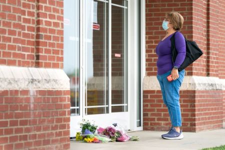 A woman reads a note explaining the temporary closure of Riverview Family Medicine and Urgent Care after the fatal shooting of Dr. Robert Lesslie and four others the previous day on April 8, 2021 in Rock Hill, South Carolina.