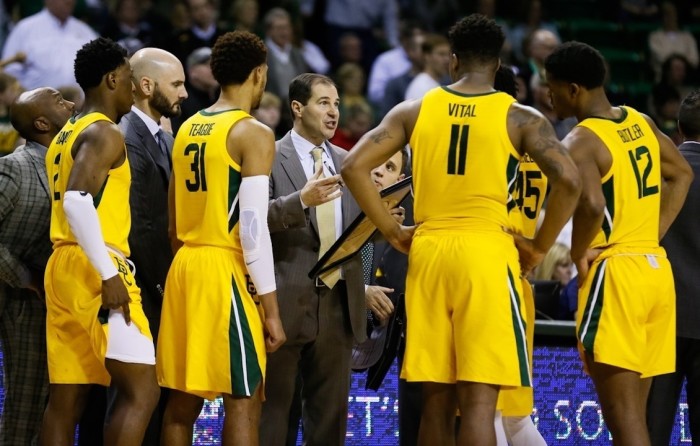Baylor University men's basketball coach Scott Drew speaks with players during a timeout. The Baylor men's basketball program won its first NCAA championship on April 5, 2021. 