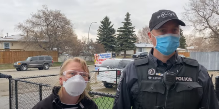 A public health officer and a police officer confront Pastor Artur Pawlowski at Street Church in Calgary, Alberta, Canada, on April 24, 2021.