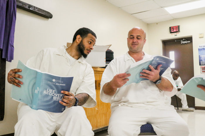 Two incarcerated men study Tyndale's Life Recovery Bible, which was distributed by Prison Fellowship. 