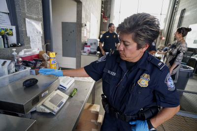 An Immigration and Customs Enforcement (ICE) agent weighs a package of Fentanyl at the San Ysidro Port of Entry on October 2, 2019, in San Ysidro, California. - Fentanyl, a powerful painkiller approved by the U.S. Food and Drug Administration for a range of conditions, has been central to the American opioid crisis which began in the late 1990s. China was the first country to manufacture deadly illegal fentanyl for the U.S. market, but the problem surged when trafficking through Mexico began around 2005. 