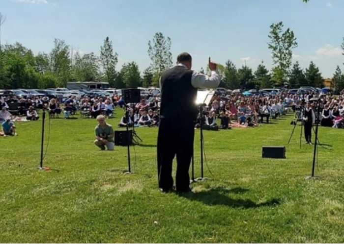 People attend an outdoor worship service in May 2021 held at the Church of God of Aylmer in Ontario, Canada.