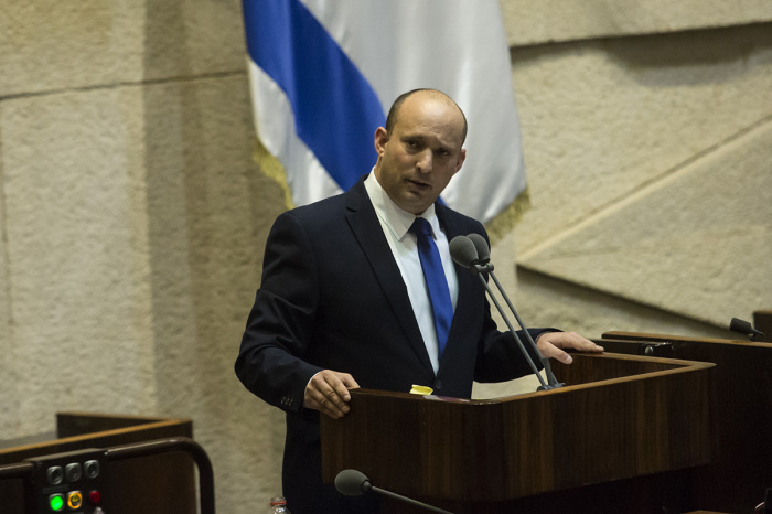 Designated Israeli Prime Minister Naftali Bennett speaks before parliament votes on a new government on June 13, 2021, in Jerusalem, Israel. The new government, a broad coalition of parties with a razor-thin majority, would end the 12-year prime ministership of Benjamin Netanyahu. 