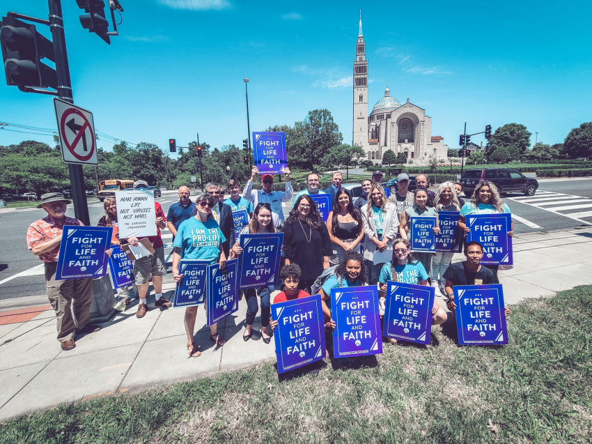 Pro-life activists pose in front of the Basilica of the Immaculate Conception in Washington, D.C., after holding a "Fight for Life & Faith" rally calling on Cardinal Wilton Gregory to support a draft document advising local ordinaries to withhold communion from pro-abortion Catholic politicians, June 16, 2021.