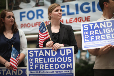 Religious freedom supporters hold a rally to praise the Supreme Court's decision in the Hobby Lobby, contraception coverage requirement case on June 30, 2014, in Chicago, Illinois. Oklahoma-based Hobby Lobby, which operates a chain of arts-and-craft stores, challenged the provision and the high court ruled 5-4 that requiring family-owned corporations to pay for insurance coverage for contraception and abortion-inducing drugs under the Affordable Care Act violated a federal law protecting religious freedom.