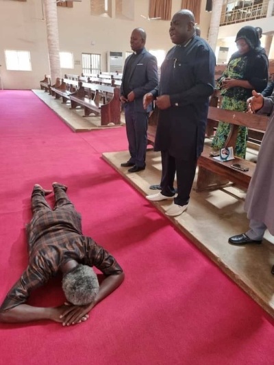 Pastor Polycarp Zongo lays down on the floor in worship after being released by terrorists following an eight-month abduction in June 2021. 