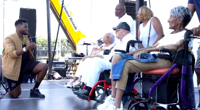 Transformation Church Pastor Michael Todd (L) thanks the only three living survivors of the Tulsa Race Massacre for 'surviving the devastation' of the riot on Sunday, June 20, 2021. The survivors (seated from left to right) are Viola Fletcher, 107; Hughes Van Ellis, 100; and Lessie Randle, 106.