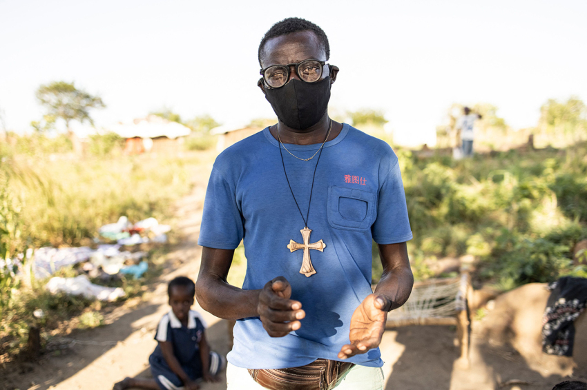 A volunteer claps as he sings with children during activities directed toward the healing for displaced children that witnessed atrocities in northern Mozambique, at a displacement settlement in Metuge on May 21, 2021. Conflict in the northern Mozambique province of Cabo Delgado that began in 2017 has now forced nearly some 700,000 people from their homes. Around 43 percent the 700,000 people displaced by the violence are children, according to the U.N. 