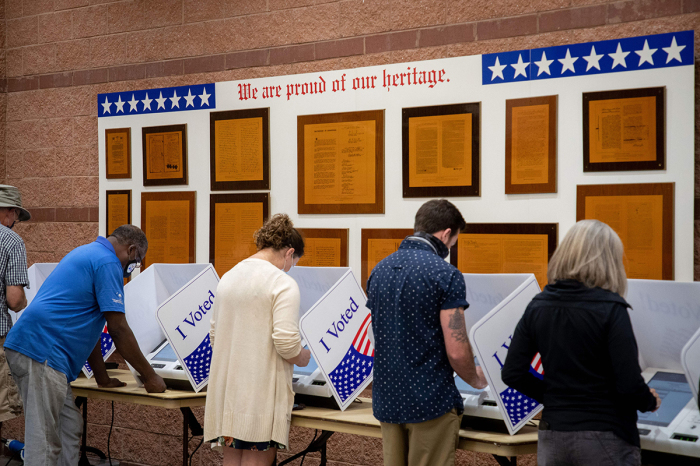 Voters cast their ballots in the voting booths at the early vote location at the Charleston Coliseum and Convention Center in North Charleston, South Carolina, on October 16, 2020. 