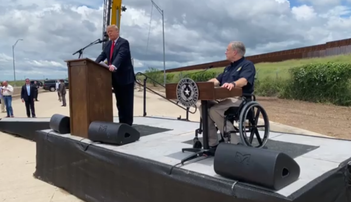 Former President Donald Trump speaks in front of an unfinished portion of the border wall in Weslaco, Texas alongside Gov. Greg Abbott, June 30, 2021.