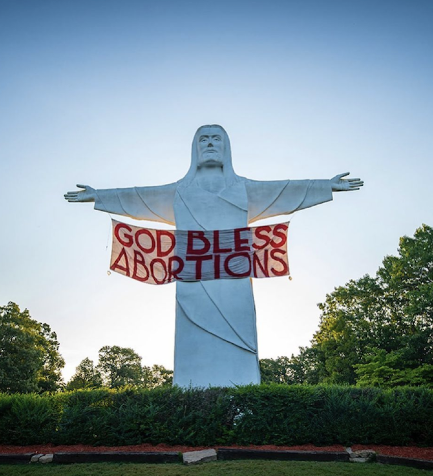 Indecline activists hung a "God Bless Abortions" banner on a 65-foot-tall statue of Jesus in Eureka Springs, Arkansas, on the night of July 8, 2021. 