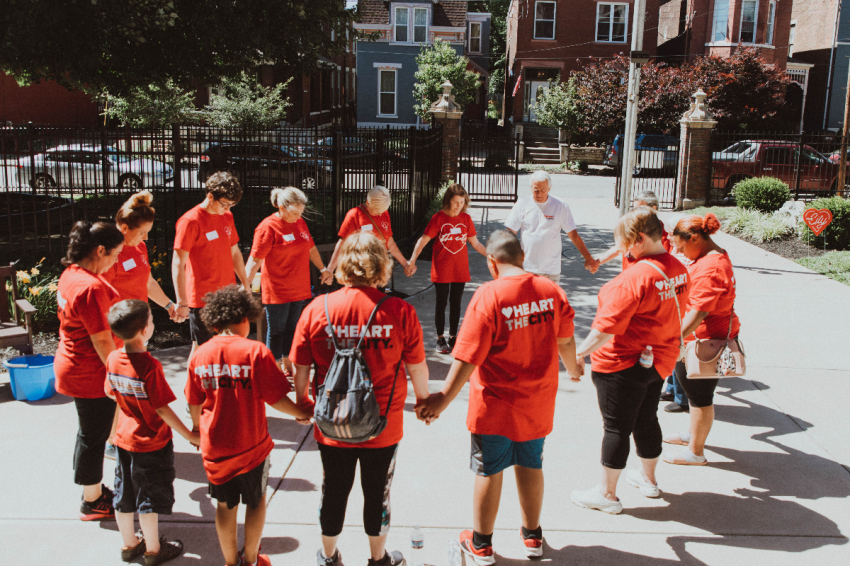 Volunteers with two-campus 7 Hills Church in Ohio and Kentucky gather for prayer during the "Heart the City" week of service.