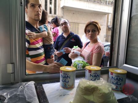 A Syrian family is aided by Aid to the Church in Needs "Drop of Milk" program in 2019. 