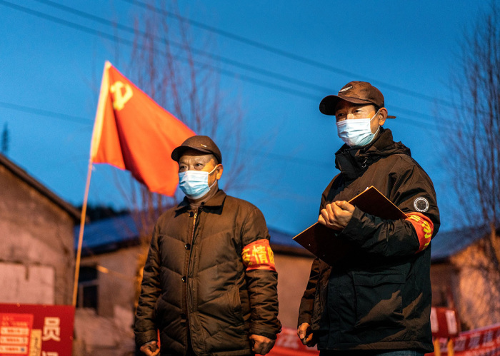 This photo taken on April 21, 2020, shows staff members keeping watch at a checkpoint in the border city of Suifenhe, in China's northeastern Heilongjiang province. 