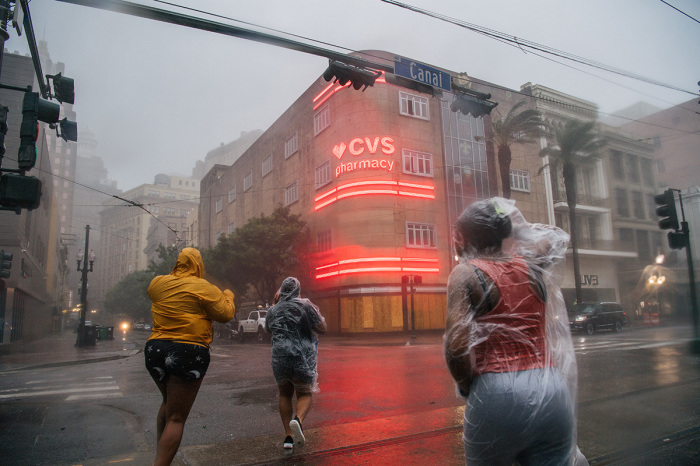 A group of people cross an intersection during Hurricane Ida on August 29, 2021, in New Orleans, Louisiana. 