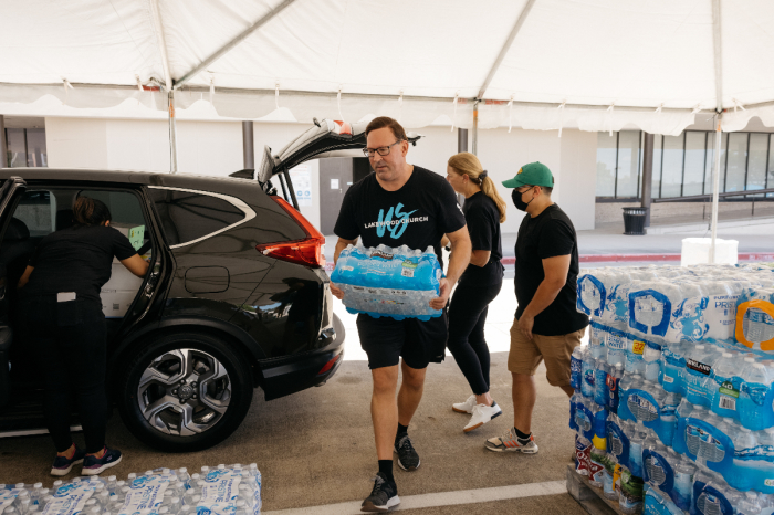 Volunteers load aid items into the back of an SUV in the wake of Hurricane Ida at Lakewood Church in Houston, Texas in August 2021. 