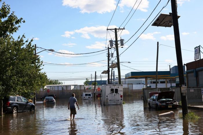 A man walks through a flooded Van Buren Street on Sept. 2, 2021 in Newark, New Jersey. 