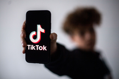 A teenager presents a smartphone with the logo of Chinese social network TikTok on January 21, 2021, in Nantes, western France. 