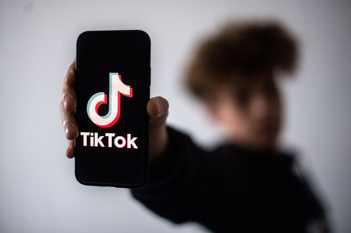 A teenager presents a smartphone with the logo of the Chinese social network Tik Tok, on January 21, 2021, in Nantes, western France. 