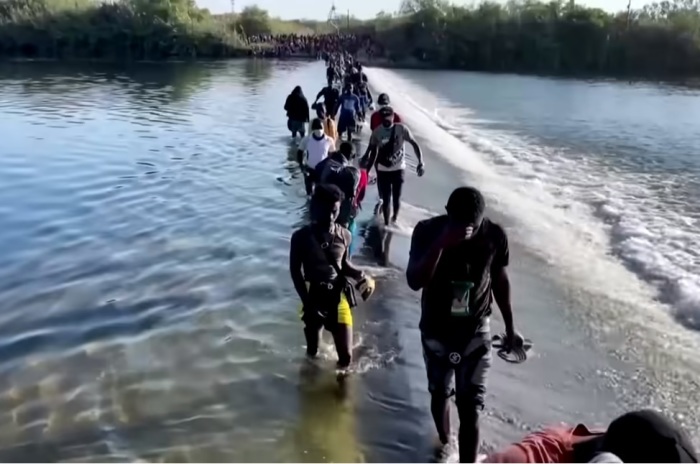 Migrants cross the border near Del Rio, Texas, in September 2021. 