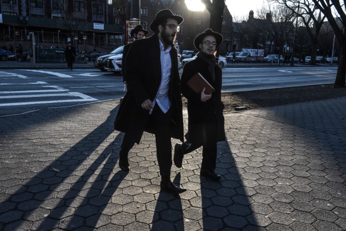 Orthodox Jews walk through the neighborhood on December 31, 2019 in the Brooklyn borough of New York City. A coalition of religious and civil rights leaders were holding a #SafetyInSolidarity rally in Grand Army Plaza to speak out against recent anti-Semitic attacks. 