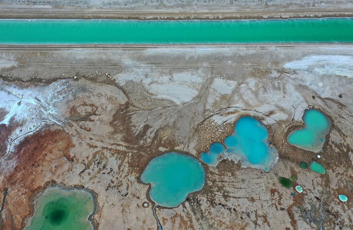 An aerial view shows salt formations in the southern part of the Dead Sea near the Israeli Neve Zohar resort on June 17, 2021. 