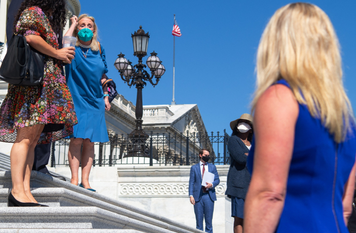 U.S. Rep. Debbie Dingell, D-Mich., shouts at U.S. Rep. Marjorie Taylor Greene (R), R-Ga., after Greene started yelling at House Democratic members of Congress as the House Democratic Women's Caucus prepares to hold a press conference promoting the Build Back Better agenda on the steps of the US Capitol in Washington, D.C., Sept. 24, 2021.