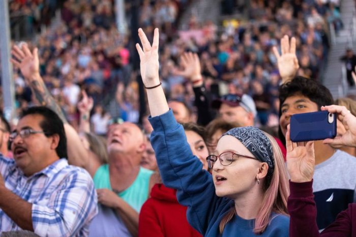 Attendees raise their hands in worship during Franklin Graham’s Route 66 “God Loves You” tour in Springfield, Missouri, on Sept. 23, 2021. 
