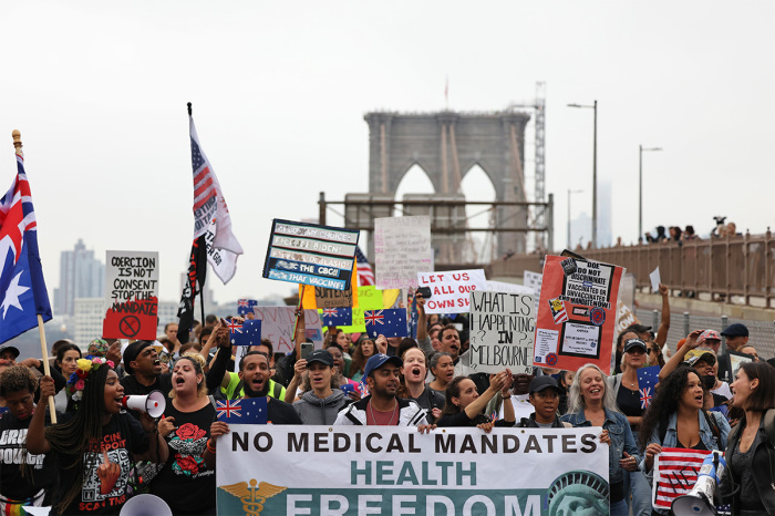 People march as they protest against NYC's coronavirus (COVID-19) vaccine mandate that went into effect today for public school employees on October 04, 2021, in New York City. According to Mayor Bill de Blasio ninety-five percent of all full-time DOE employees were vaccinated, that includes 96% of all teachers and 99% of all principals. Almost 8,000 out of all 148,000 DOE employees, 3,000 out of 78,000 teachers and 12 out of 1,600 principals are unvaccinated with most being replaced by substitutes. People who remain unvaccinated make up nearly 97% of all COVID-19 hospitalizations across NYC. 