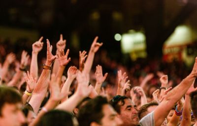 Attendees raise their hands in worship at SoCal Harvest outreach event in Anaheim, California on Oct. 3, 2021. 