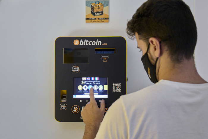 An employee demonstrates how the Bitcoin ATM works at the BitBase Store on August 09, 2021, in Palma de Mallorca, Spain. 