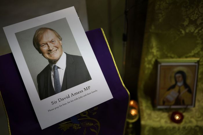 A photograph of Sir David Amess is displayed during a vigil held at Saint Peter's Catholic Church following the stabbing of U.K. Conservative MP Sir David Amess as he met with constituents at a constituency surgery on October 15, 2021 in Leigh-on-Sea, England. 