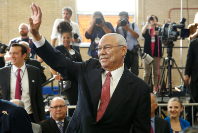 Former US Secretary of State Colin Powell waves before arrival of President Barack Obama at Benjamin Banneker Academic High School in Washington, D.C. on Oct. 17, 2016. 
