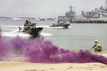 Members of SEAL Team 18 perform a demonstration at Joint Expeditionary Base Little Creek in Norfolk, Virginia, on June 20, 2014 for the Navy Employer Recognition Event.