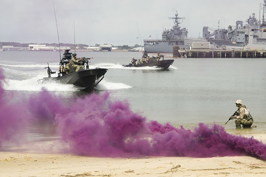 Members of SEAL Team 18 perform a demonstration at Joint Expeditionary Base Little Creek in Norfolk, Virginia, on June 20, 2014 for the Navy Employer Recognition Event.