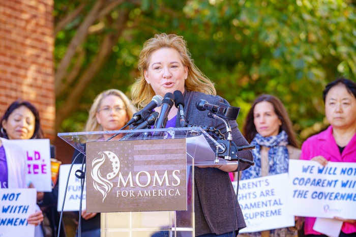 Kimberly Fletcher, president of Moms for America, speaks at a protest outside the National School Boards Association headquarters in Arlington, Virginia, on Oct. 27, 2021.