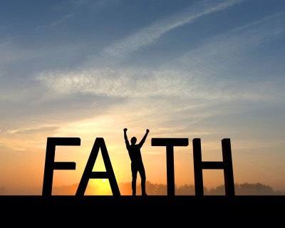 The word faith is silhouetted against an orange and blue sunset. The I in the word is made from a figure with their arms raised up in the air in a successful victory pose.