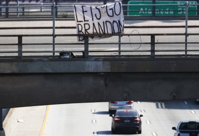 A 'Let's Go Brandon' sign hangs on an overpass near a ‘March for Freedom’ rally where people were demonstrating against the L.A. City Council’s COVID-19 vaccine mandate for city employees and contractors on November 8, 2021 in Los Angeles, California. The City Council has set a deadline of December 18 for all city employees and contractors to be vaccinated except for those who have religious or medical exemptions.