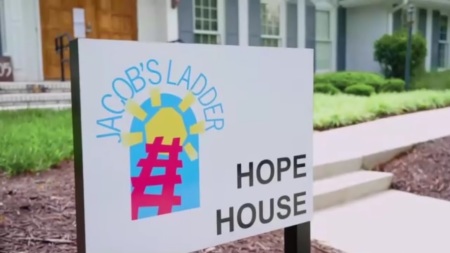 A sign sits outside of the of the Jacob's Ladder School in Roswell, Georgia.