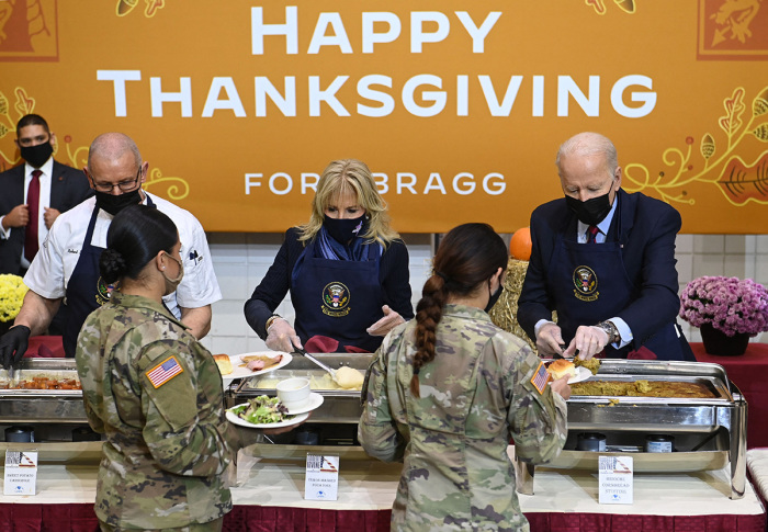 U.S. President Joe Biden and first lady Jill Biden serve food to soldiers at Fort Bragg to mark the upcoming Thanksgiving holiday on November 22, 2021, in Fort Bragg, North Carolina. 
