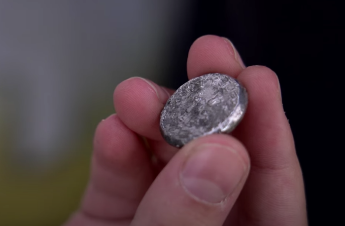 An ancient coin believed to have been printed by Jewish rebels during the First Jewish-Roman War is shown after it was discovered at Emek Tzurim National Park in Jerusalem in November 2021. 