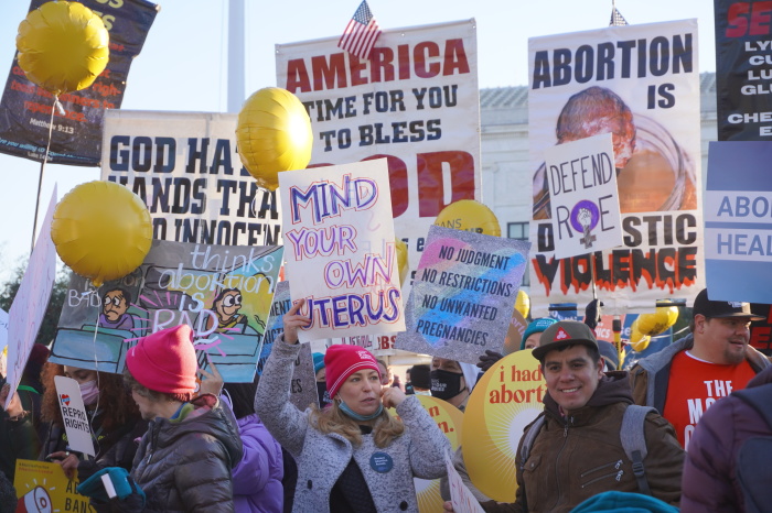 Pro-life and pro-choice demonstrators stand outside the U.S. Supreme Court building in Washington, D.C., during the oral arguments for Dobbs v. Jackson's Women's Health on Dec. 1, 2021.