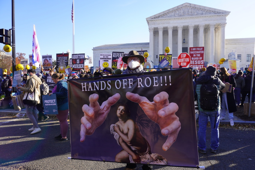 A pro-choice demonstrator stands outside the U.S. Supreme Court building in Washington, D.C. on Dec. 1, 2021, during the oral arguments for Dobbs v. Jackson Women's Health Organization.