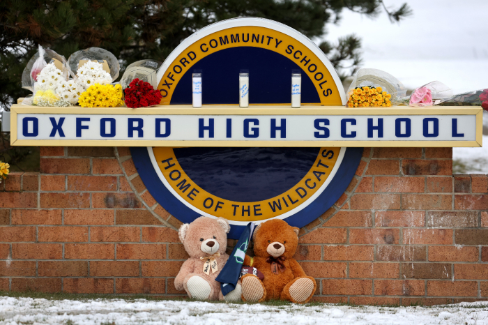 Stuffed bears and flowers are gathered at a makeshift memorial outside of Oxford High School on December 01, 2021, in Oxford, Michigan after four students were killed and seven injured when a gunman opened fire on students at the school.