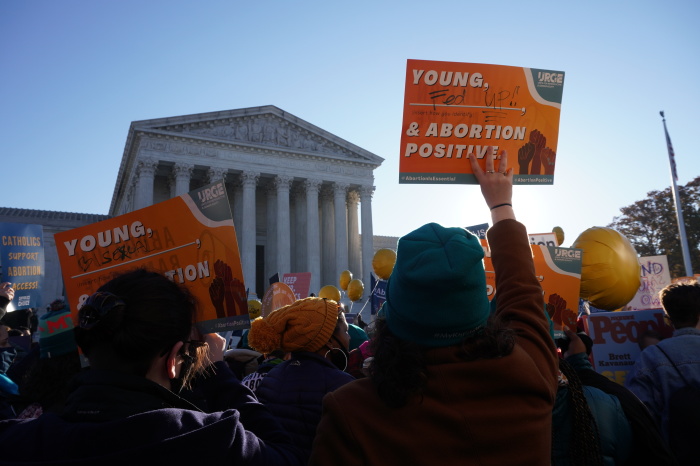 Demonstrators stand outside the U.S. Supreme Court building in Washington, D.C. during the oral arguments for Dobbs v. Jackson's Women's Health on Dec. 1, 2021.