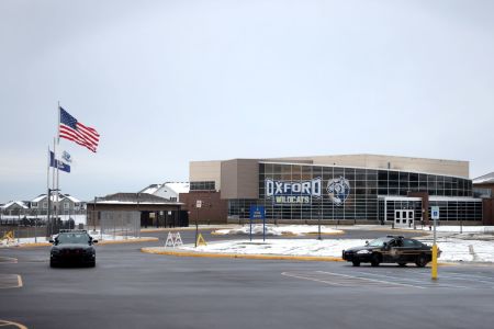 Police vehicles remain parked outside of Oxford High School on December 01, 2021 in Oxford, Michigan. Yesterday, three students were killed and eight others were injured when a gunman began shooting at the school. A 15-year-old sophomore, believed to be the only gunman, is in custody.