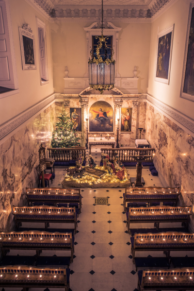 Christmas decorations are set out in the private chapel at Holkham Hall. 