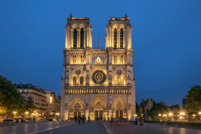 The cathedral of Notre Dame in Paris all lit up at night.